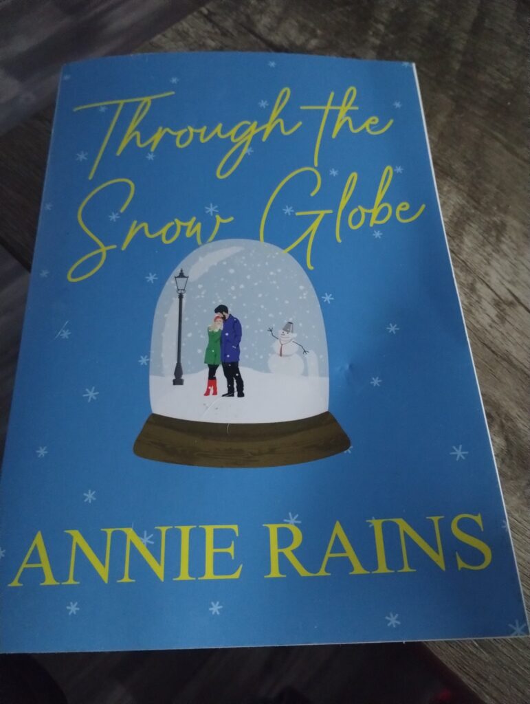  Through the Snow Globe: A Charming and Uplifting Holiday Read by Annie Rains